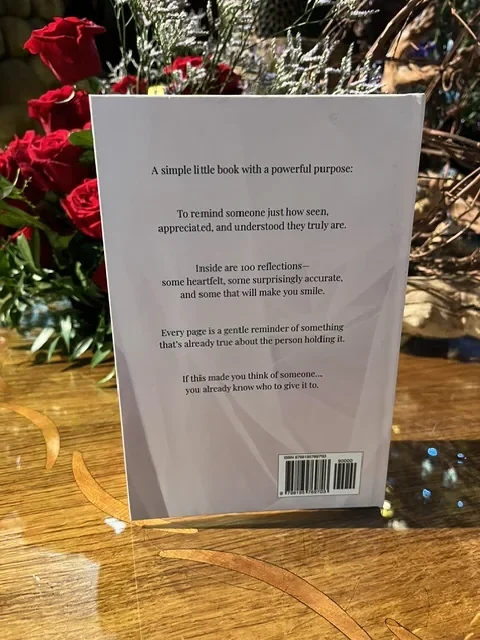 Back cover of I Saw This and Thought of You beside red roses